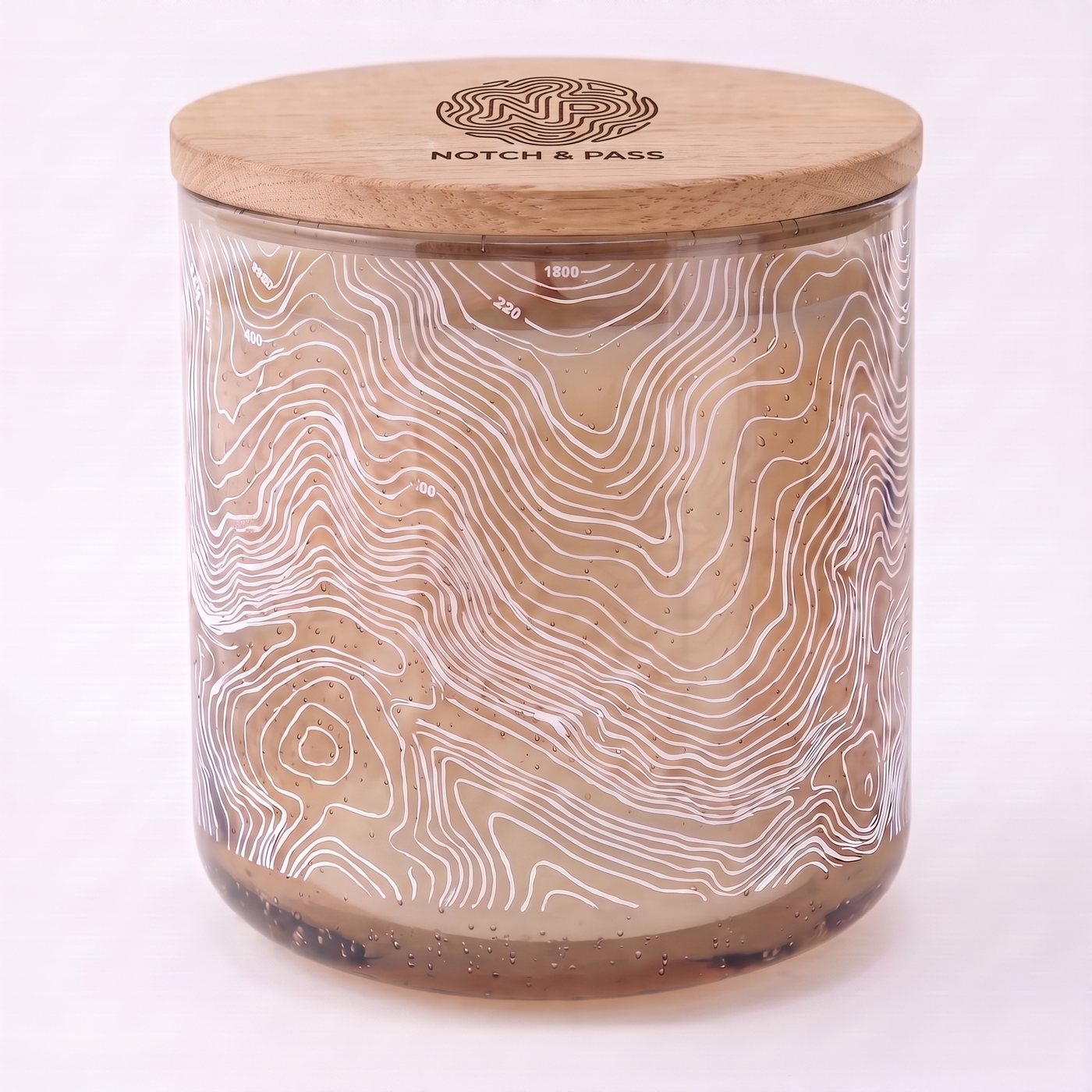 The Pine Needle & Sap candle: sand bubble glass, white contour print, pine lid with the mark burnt in